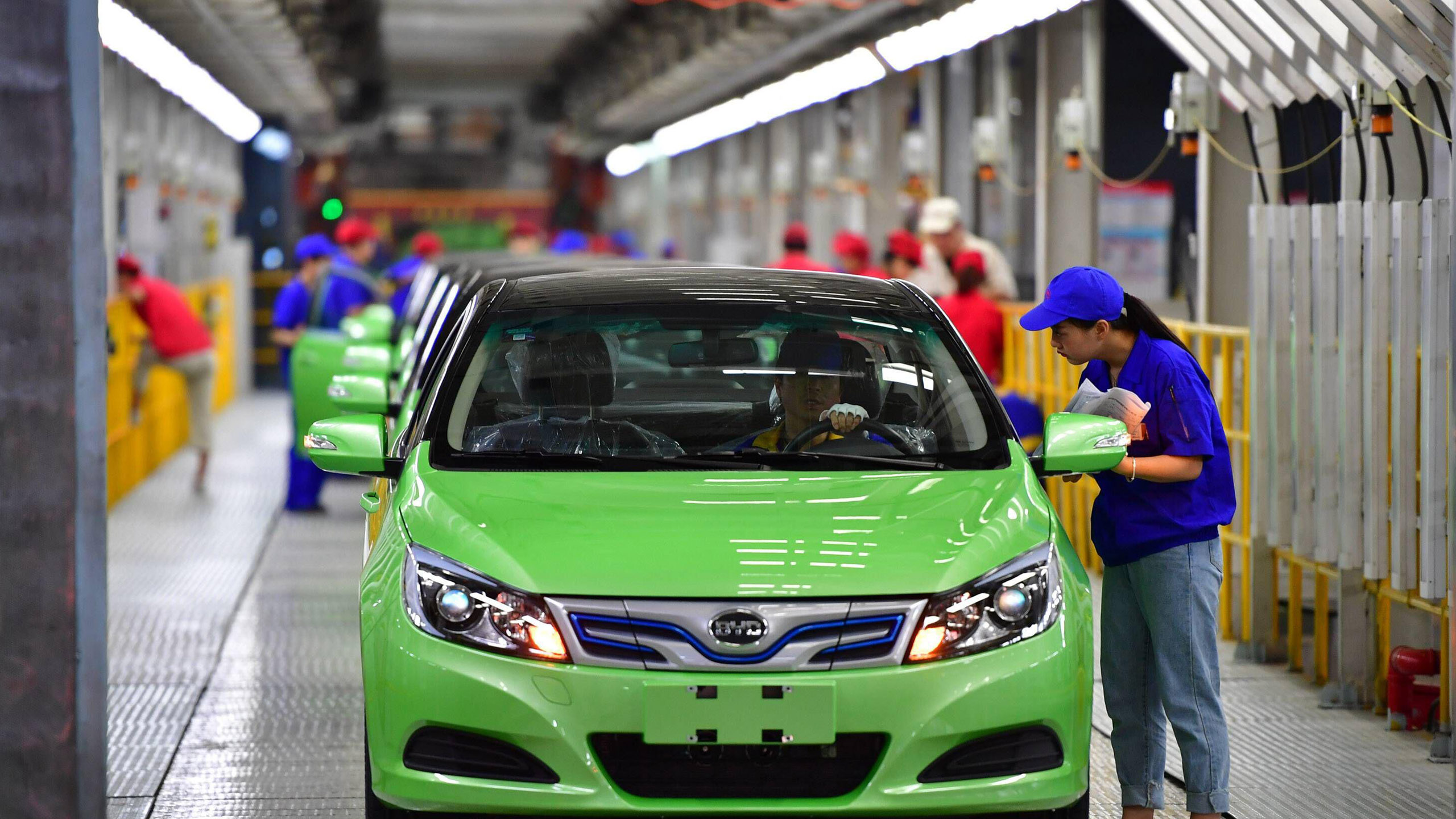 Employees at an e-car production plant in China