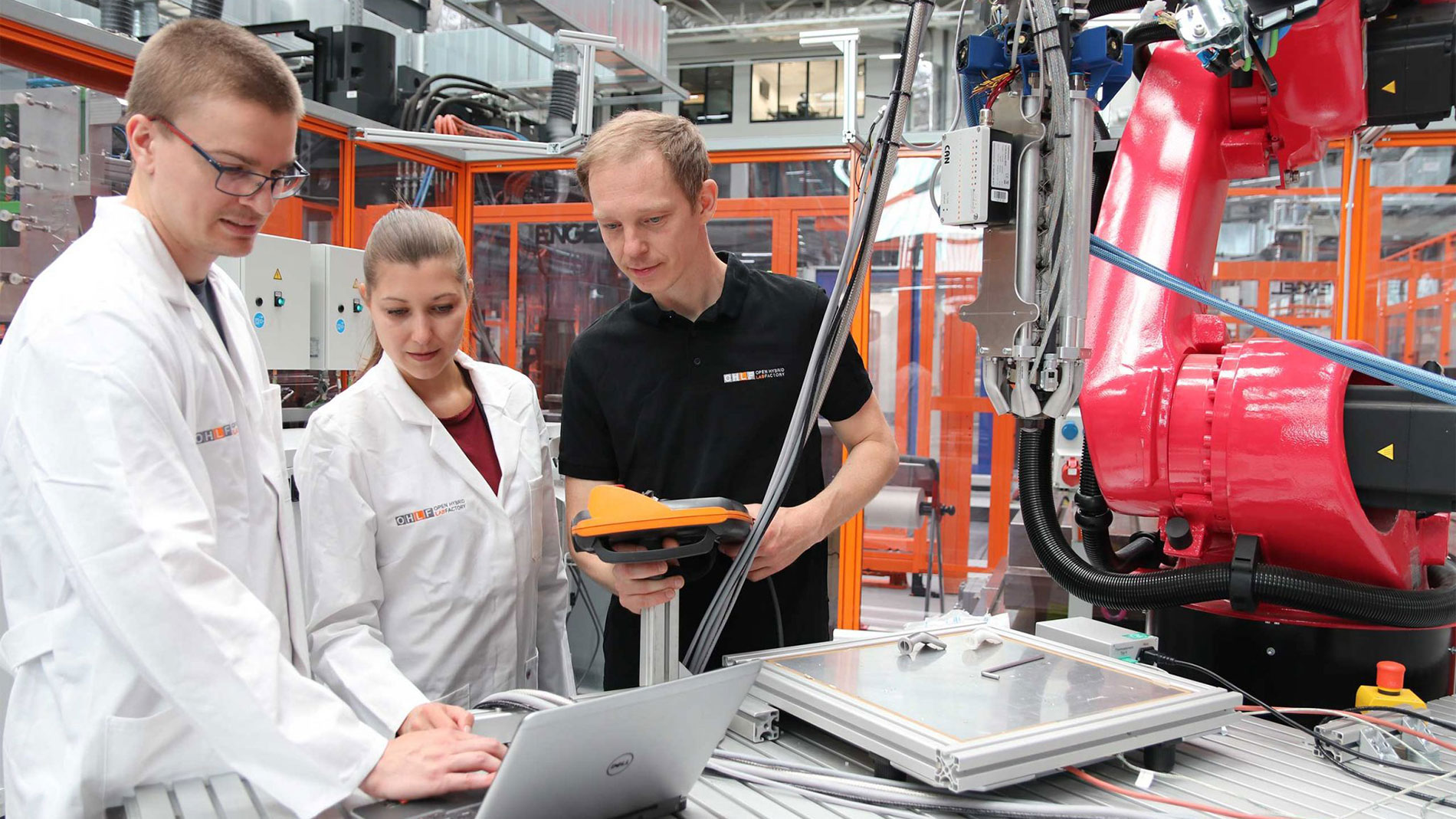 Engineers collaborating on industrial robotic equipment