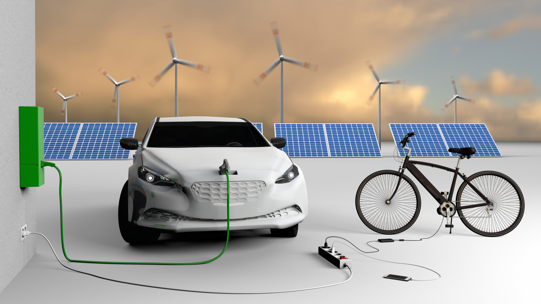 Electric car plugged into a wall box next to a bicycle
