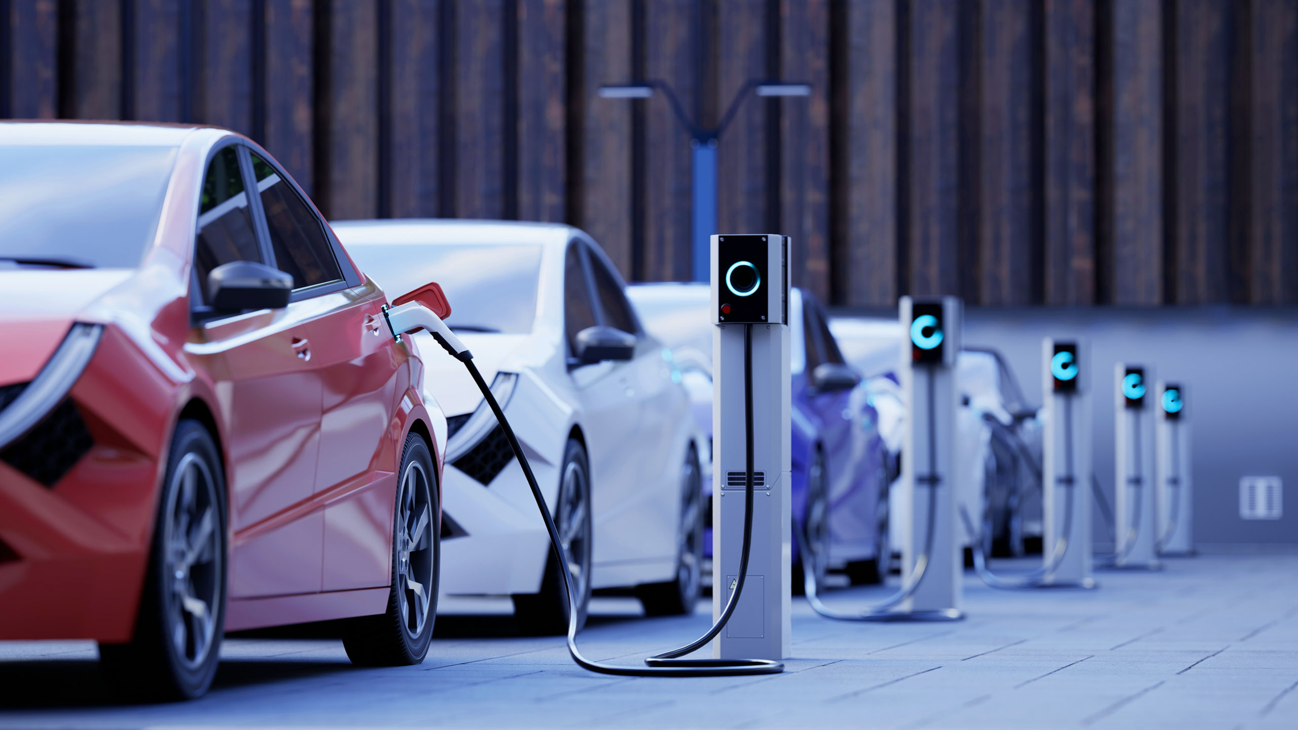 Row of electric cars charging at public stations