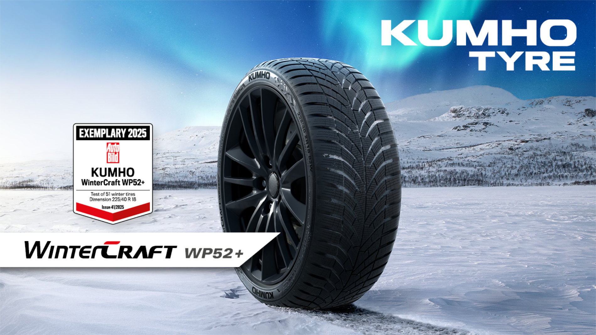 Kumho WinterCraft WP52+ winter tyre on a snowy road with Auto Bild 2025 test award, set against a winter mountain landscape.