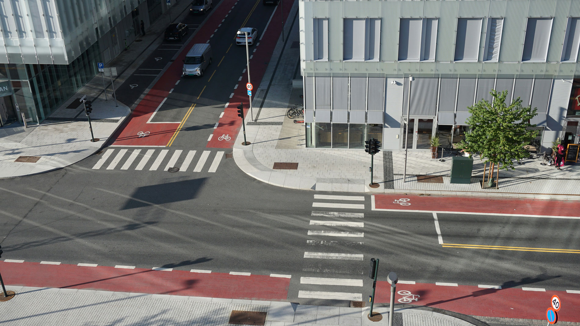 Aerial view of modern city intersection with cycle lanes and pedestrian crossings