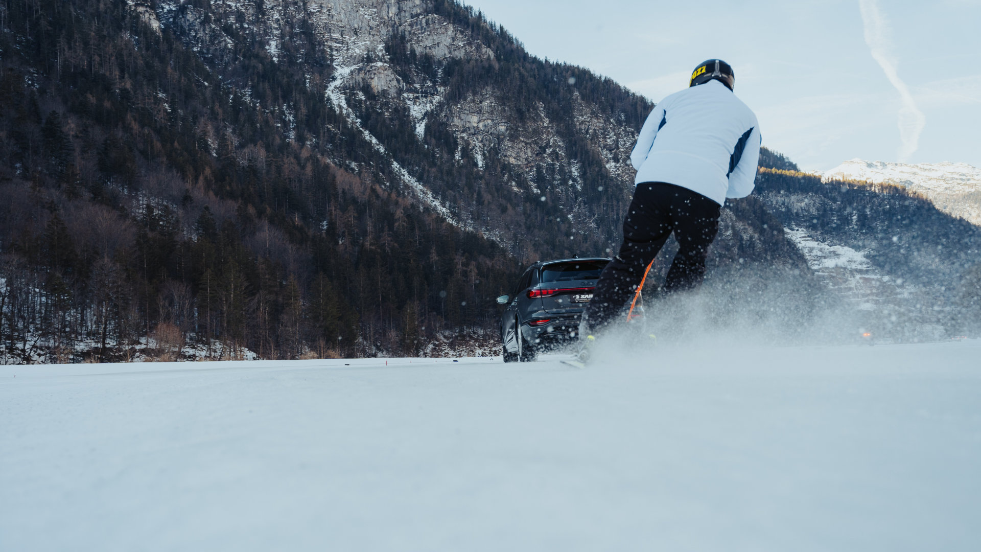 Car pulls skier in the snow