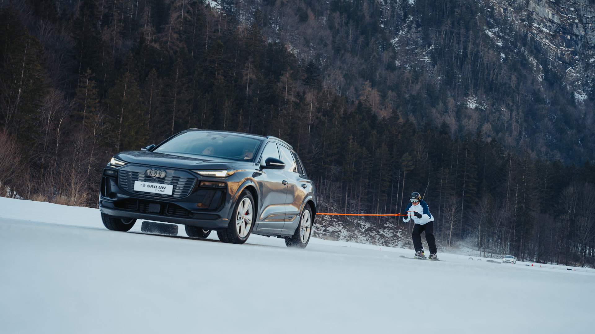 Car pulls skier in the snow