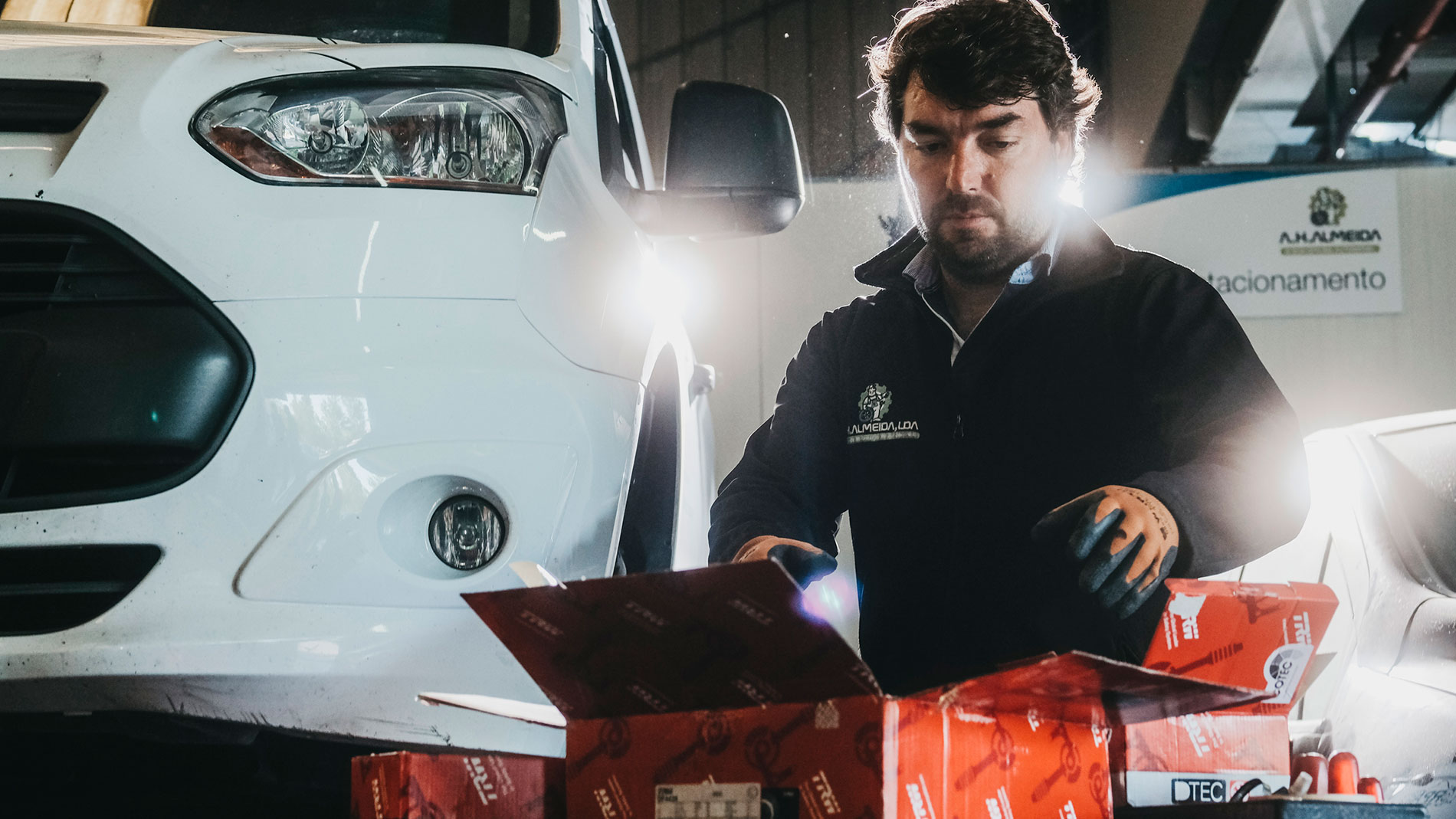 Automotive mechanic opening spare-parts boxes