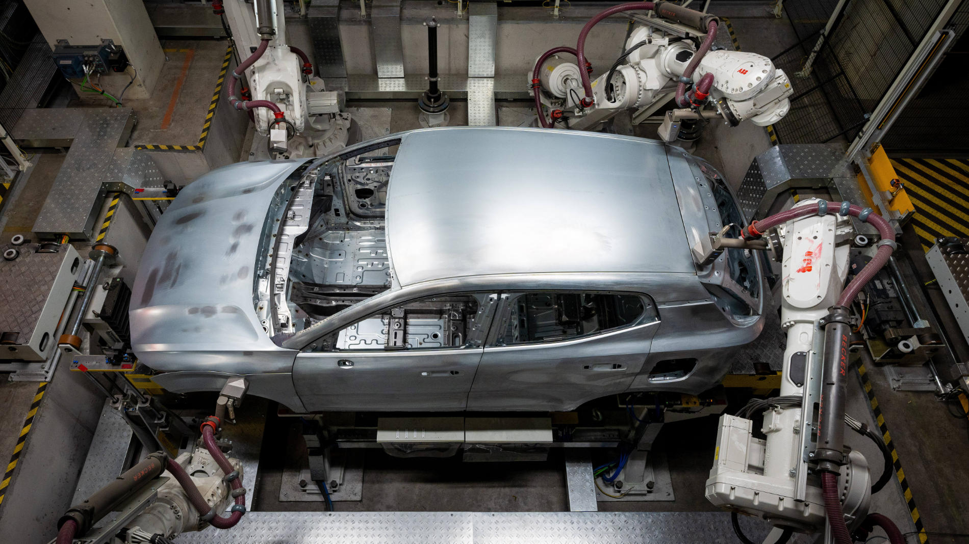 Car body being processed by multiple industrial robots
