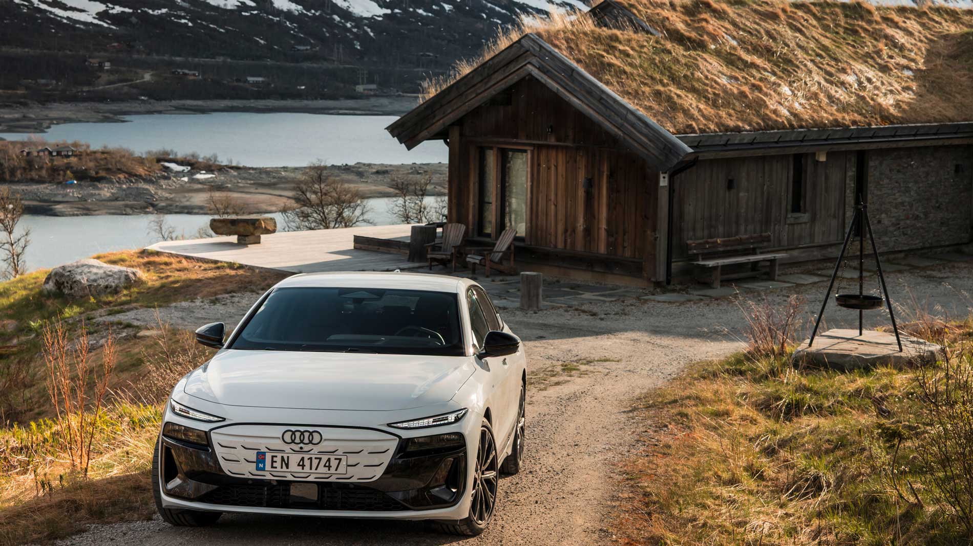 A white Audi A6 e-tron in the countryside
