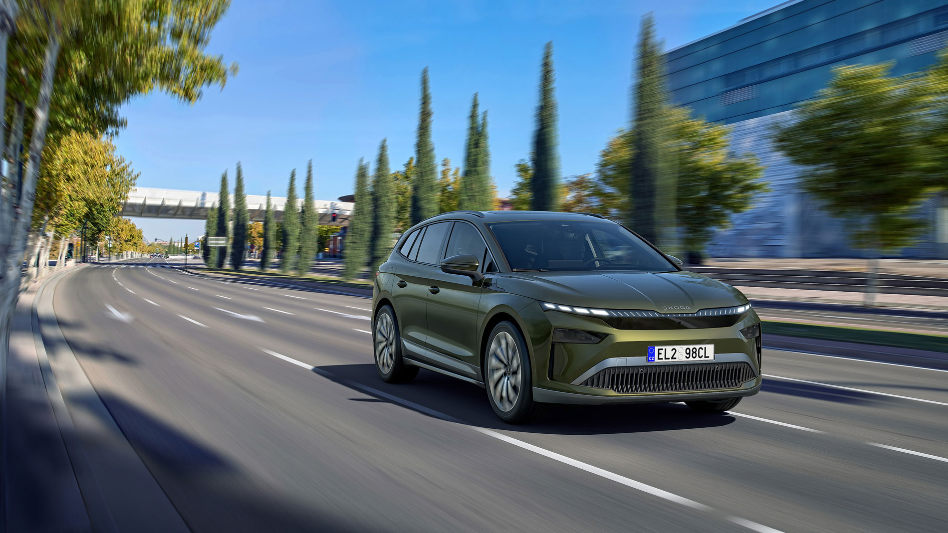 A green Škoda Enyaq is driving on the motorway