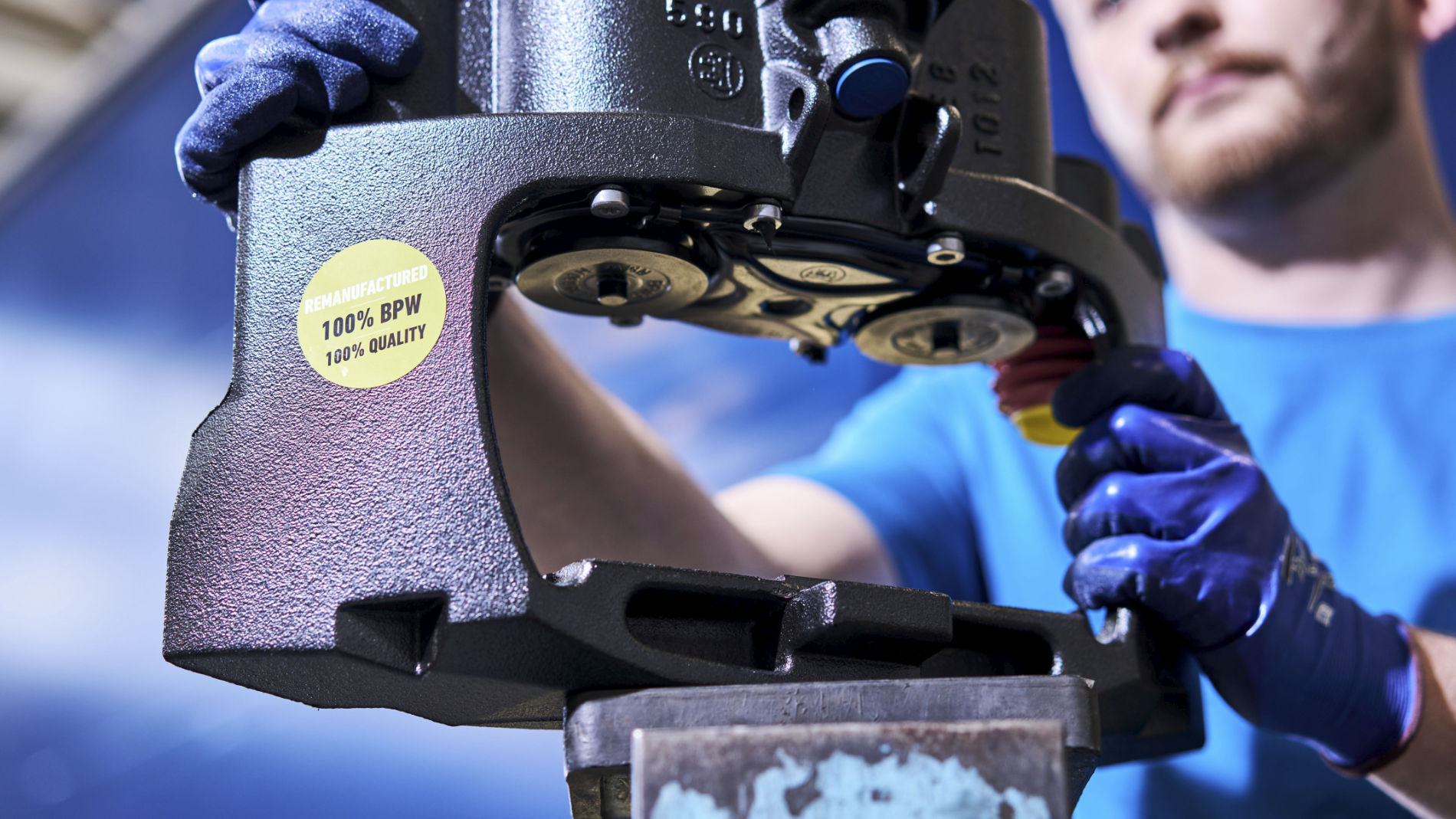 Technician remanufacturing BPW component for commercial trailer